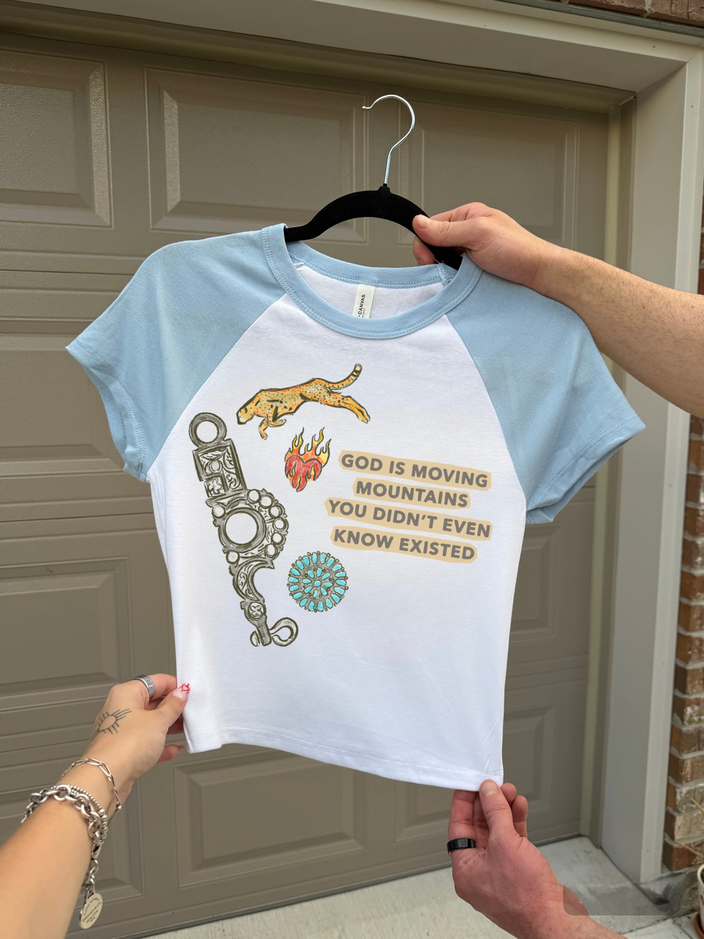 God Is Moving Mountains Baby Tee